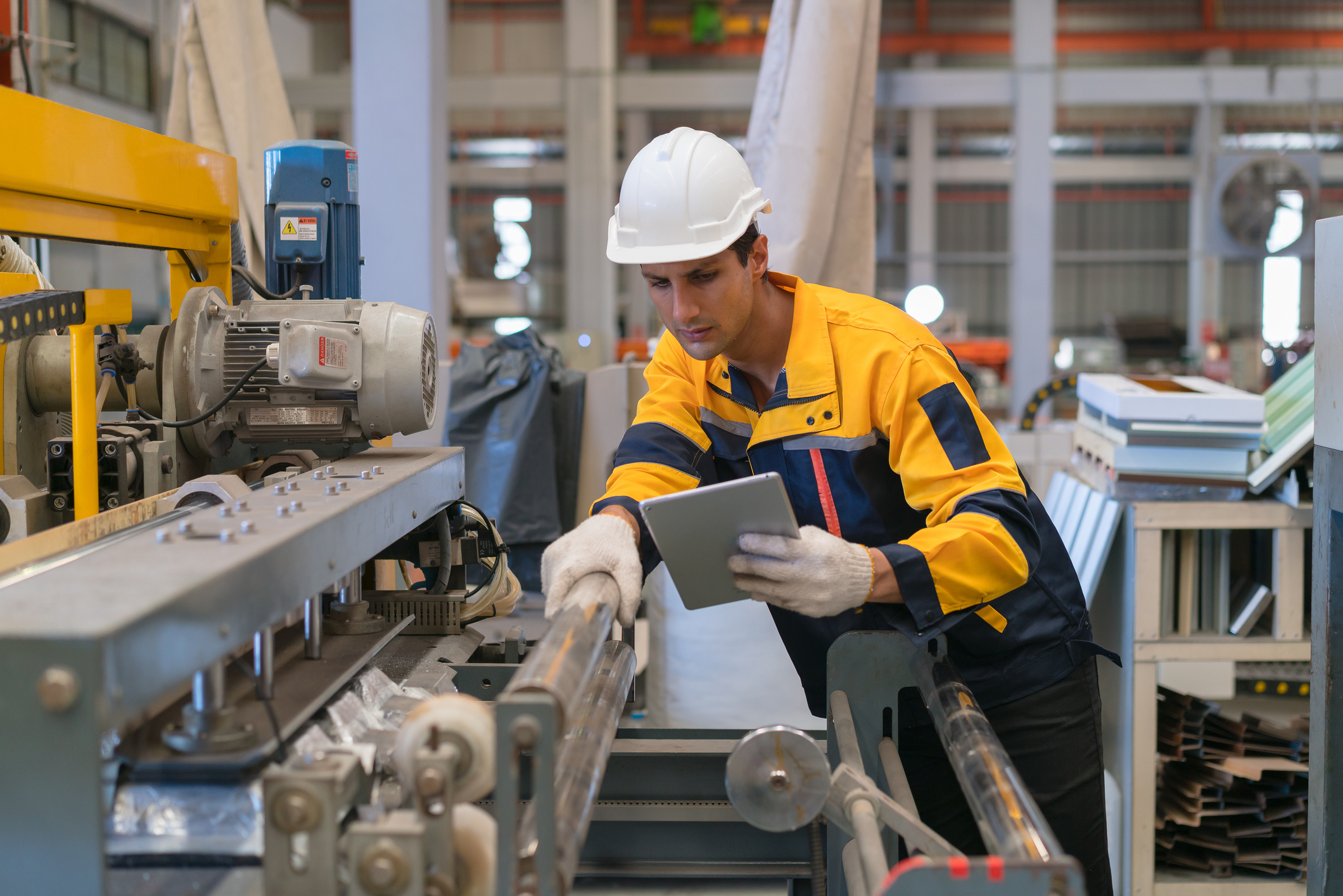 Professional heavy industry engineer worker wearing safety uniform in a metal manufacture warehouse , maintenance service check for safety first concept .